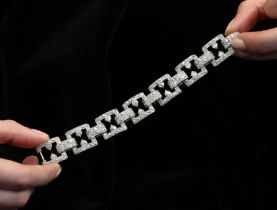 An early 20th century diamond set bracelet, circa 1920, the seven openwork square panels pave set