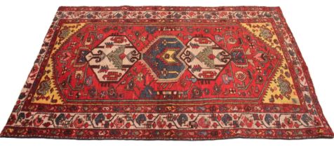 A multi coloured ground Persian Heriz rug, Northern Iran, the central red ground with hexagonal