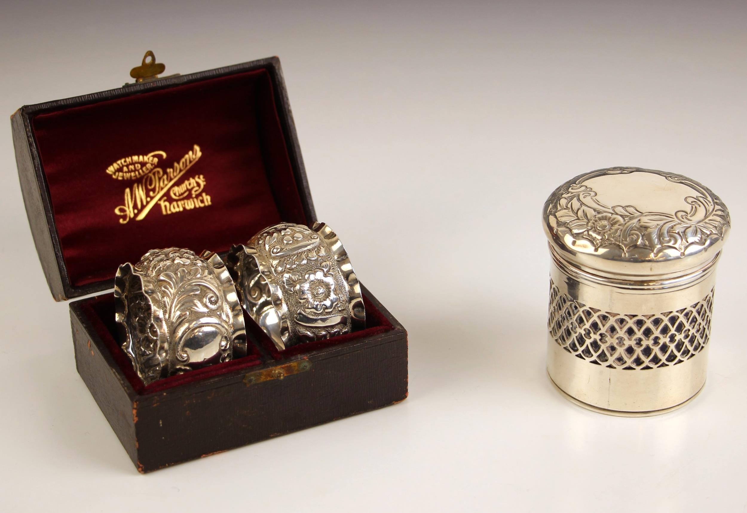 A pair of Victorian silver napkin rings, ‘SG’ Birmingham 1898, of circular form with lobed rim above