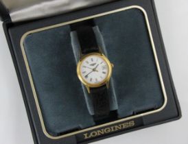 A gold plated ladies Longines wristwatch, the circular white dial with Roman numerals, set to