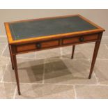 An Edwardian satinwood and mahogany cross banded Sheraton revival writing desk, the top inset with a