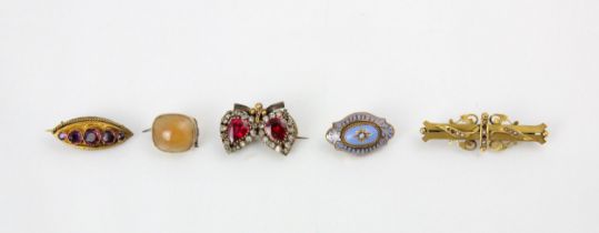 A group of five brooches, including a 9ct yellow gold Edwardian seed pearl example, the bar brooch