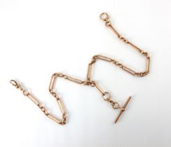 A 20th century 9ct albert chain, the elongated links with triple circular link detail, suspending '