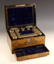 A burr walnut lady's dressing vanity case, 19th century, the hinged cover with vacant mother of