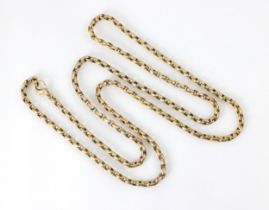 An early 20th century style yellow metal necklace, the lightly faceted trace link chain with