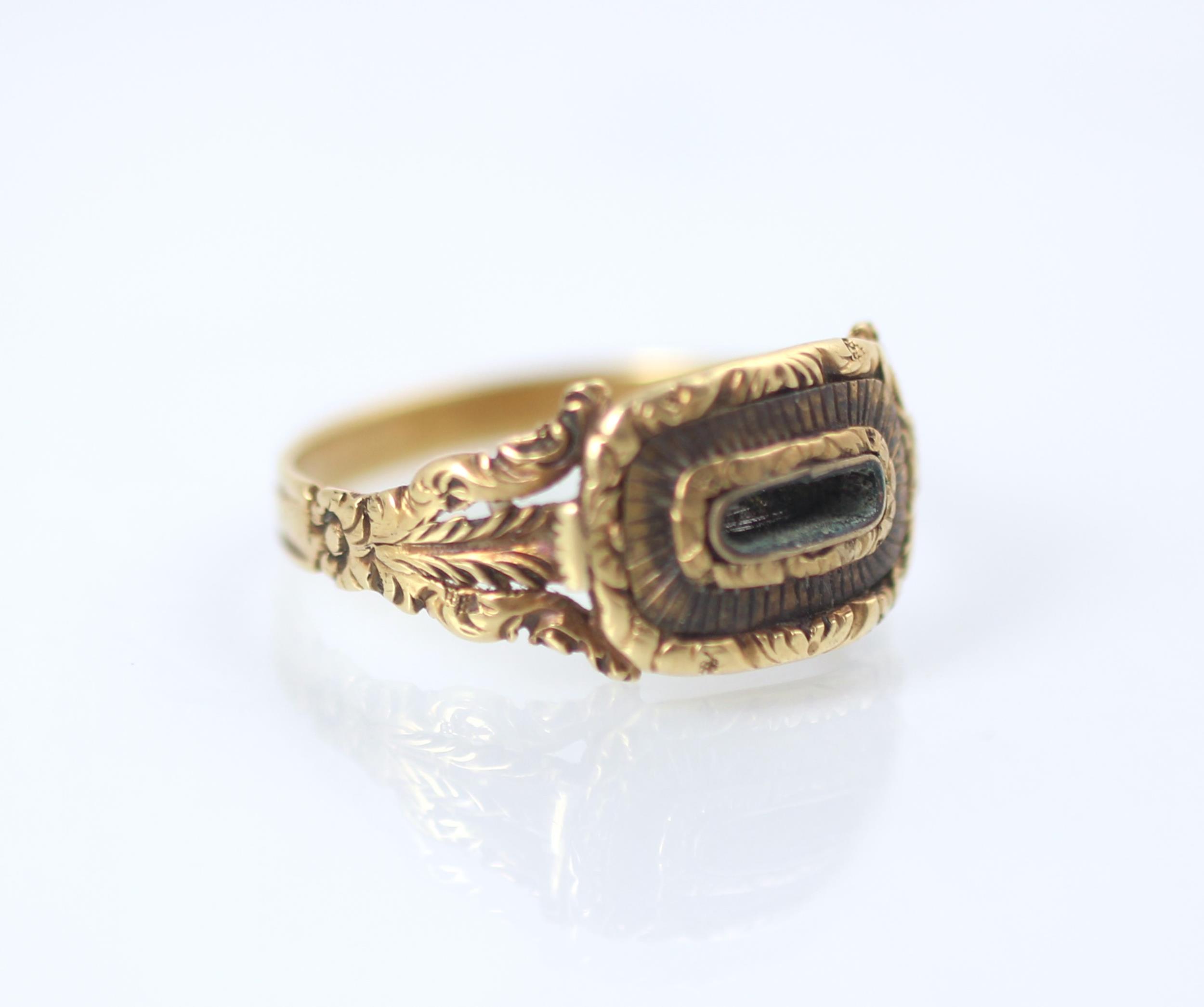 A 19th century style yellow metal mourning ring, the central vacant locket within carved mount and - Image 3 of 4