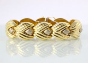 A yellow metal statement bracelet, the plain polished stylised leaf designed links with matte detail