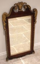 A George II walnut, giltwood and gesso pier mirror, the acanthus crest enclosed by a twin swan