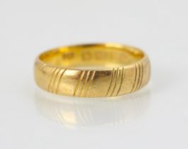 An engraved 22ct yellow gold wedding band, with striped decoration, stamped 'SH' Birmingham,