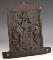 A 17th century carved oak and polychrome painted armorial panel, the central rectangular panel