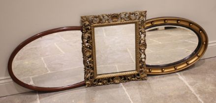 A giltwood Florentine wall mirror, late 19th century, the scrolling open work foliate frame