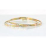 A tri-coloured yellow metal bracelet, the double strand of square flat links with engraved detail,