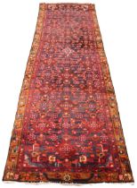 A full pile Persian Hamadan runner, in red and blue colourways, the all over trailing geometric