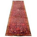 A full pile Persian Hamadan runner, in red and blue colourways, the all over trailing geometric