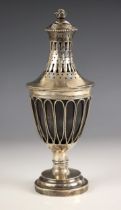An 18th century white metal mounted coconut cup and cover, the pierced, tapered removable cover with