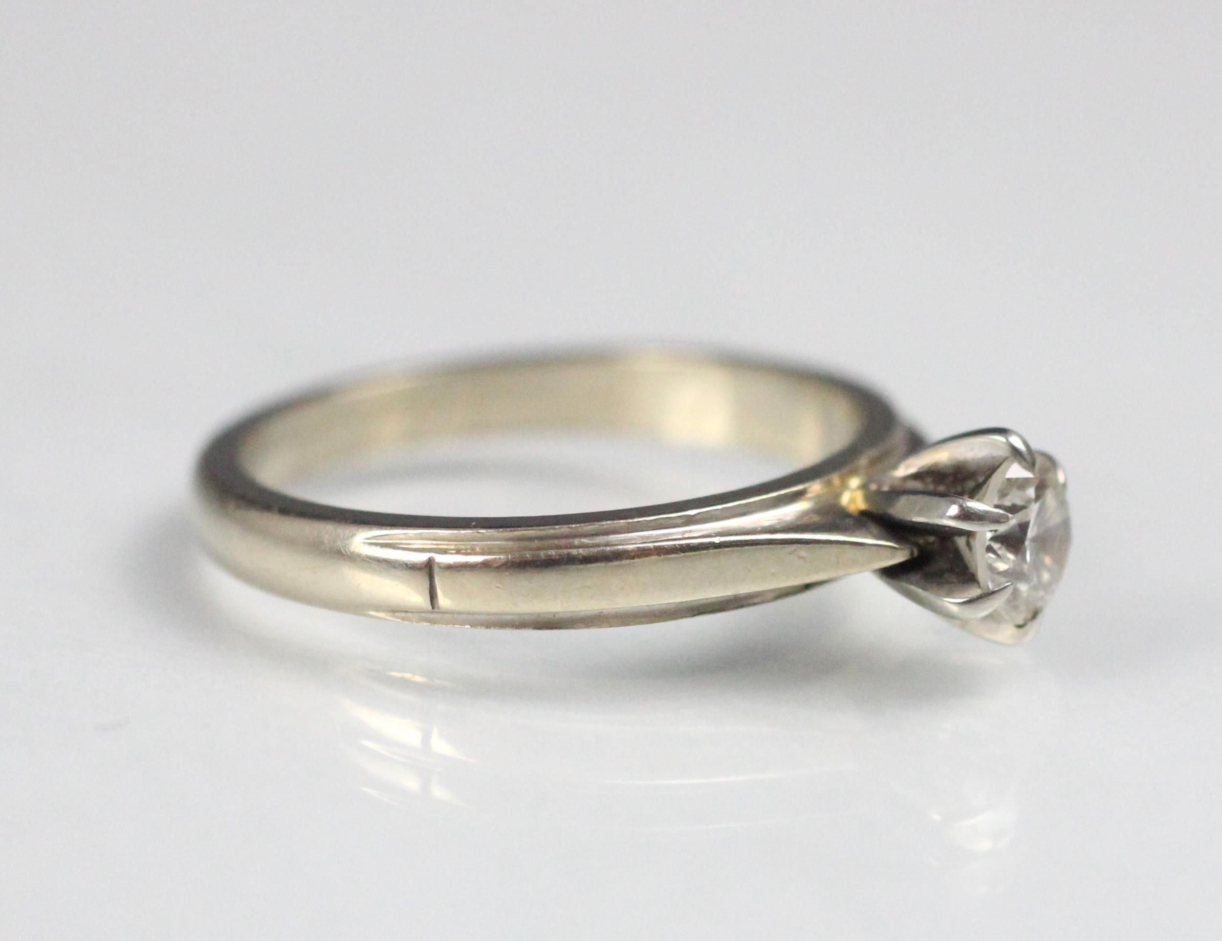 A certified diamond solitaire ring, the central round cut diamond claw set in raised mount, upon - Image 2 of 5