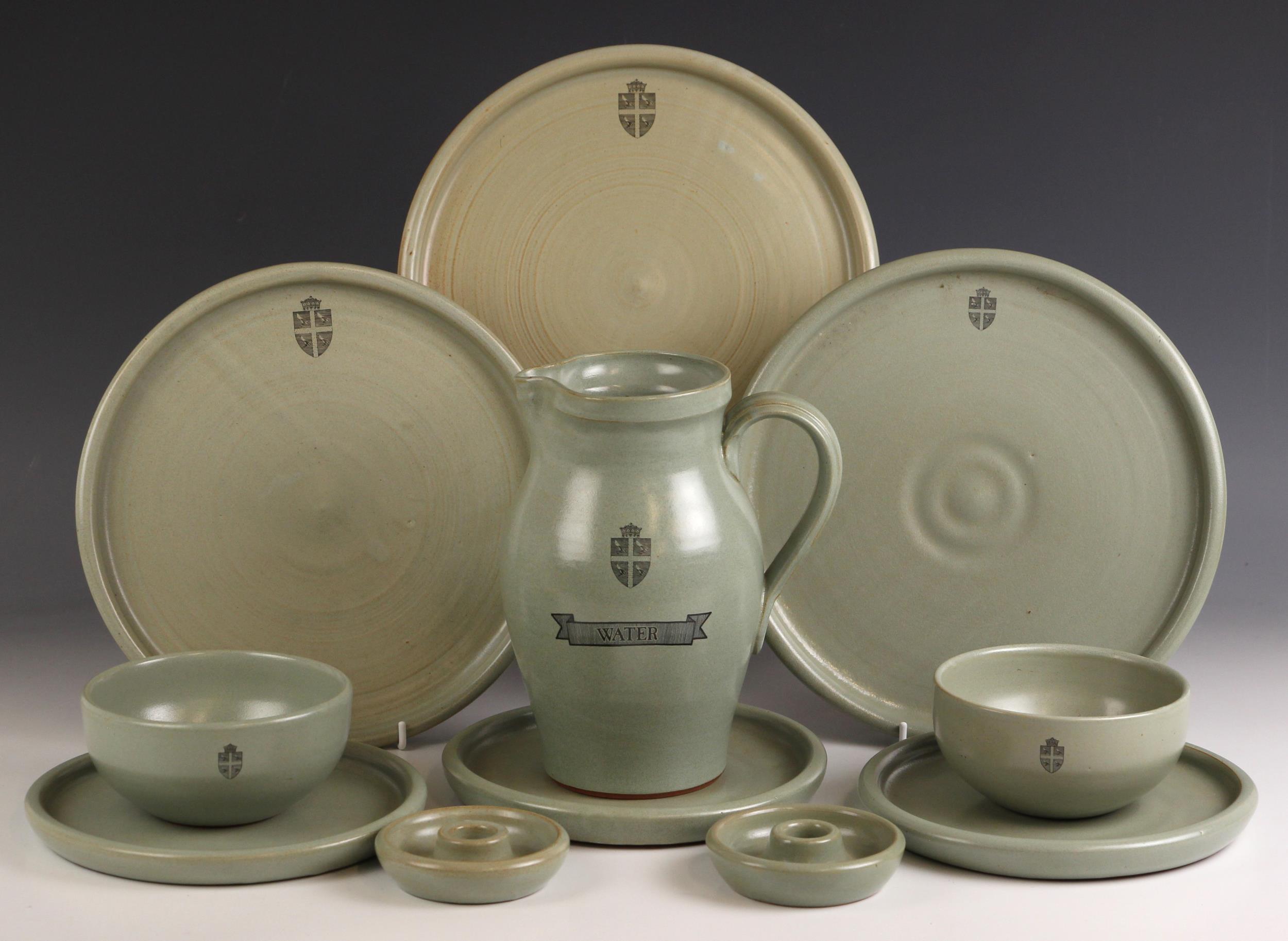 A selection of Fulham pottery wares, each in a celadon glaze, and black printed heraldic crest (