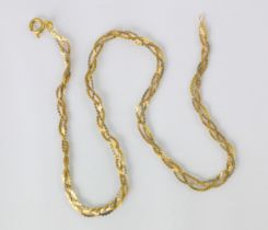 A two tone yellow metal necklace, the flat link plaited necklace with bolt ring clasp, stamped ‘750’