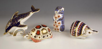 Four Royal Crown Derby paperweights, comprising: a dolphin, 18.5cm long, a squirrel, 10.5cm high,