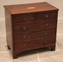 A George III and later constructed inlaid mahogany chest of drawers, the top centred with an