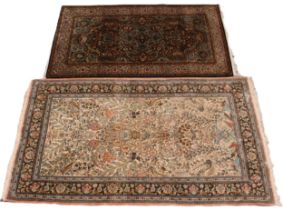 A Persian silk and wool mix rug, the central field with a 'Tree of Life' design, encapsulating