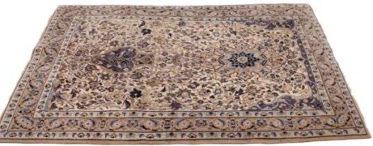 A Persian wool rug in ivory, blue and mushroom colourways, the central field with a vase of blooms