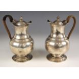 A pair of George V silver coffee pots, Pairpoint Brothers, London 1918, the wicker wrapped handle