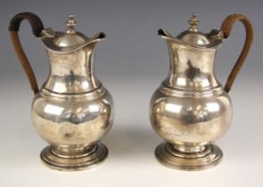 A pair of George V silver coffee pots, Pairpoint Brothers, London 1918, the wicker wrapped handle