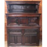 A Welsh joined oak cwpwrdd tridarn, early 18th century, the upper tier with a panel back and