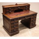 A Victorian carved oak Green man desk, the superstructure back with a three quarter gallery and a