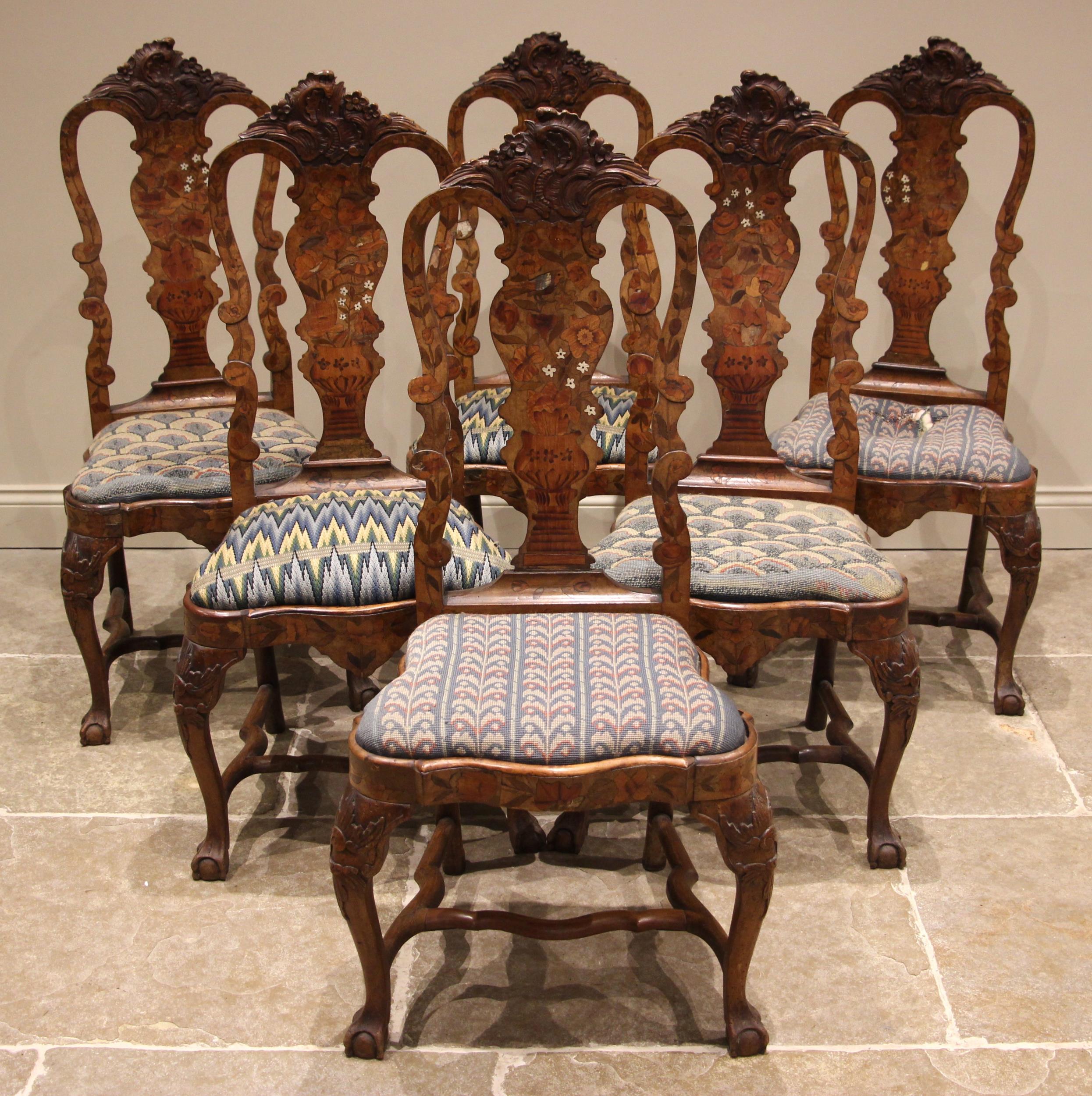 A set of six Dutch marquetry walnut dining chairs, mid 18th century, each with a