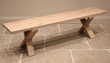 A contemporary Heals 'Oslo' natural oak bench, the slab top upon a pair of 'X' trestle type