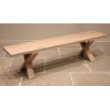 A contemporary Heals 'Oslo' natural oak bench, the slab top upon a pair of 'X' trestle type