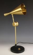 A Tom Dixon, London, 'Beat' brass desk lamp, the cone shaped shade upon a slender articulated arm,