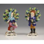 Two English porcelain bocage figures, one modelled as a girl selling flowers, 10cm high, the other