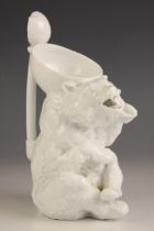 An unusual continental porcelain white glazed bear form jug, 19th century, modelled as a seated