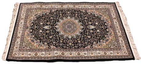 A black ground fine woven Iranian rug, the all over floral design with a central lozenge