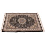 A black ground fine woven Iranian rug, the all over floral design with a central lozenge