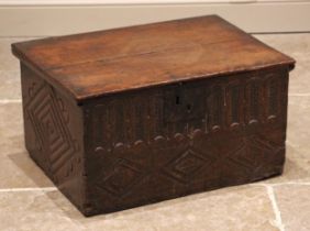 A 17th century oak bible/carriage box, the hinged cover over a nulled frieze and carved lozenge