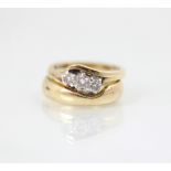 A 9ct yellow gold bespoke diamond ring, the central round cut diamond with smaller diamond to each