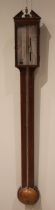 A George III mahogany stick barometer, the architectural pediment over an 18cm silvered register,