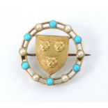 A gold coloured brooch, the circular brooch with paste pearls and turquoise coloured stones, with