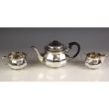 A George V silver tea service, Walker and Hall, Sheffield 1930, comprising a teapot, sugar bowl
