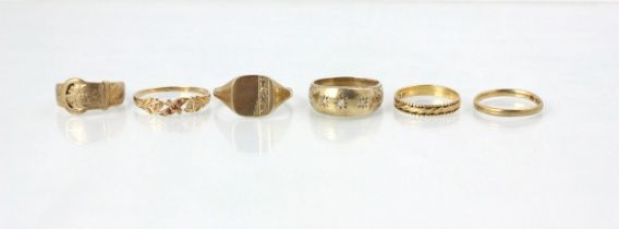 A group of six yellow metal rings, including a 9ct yellow gold signet ring, a 9ct yellow gold