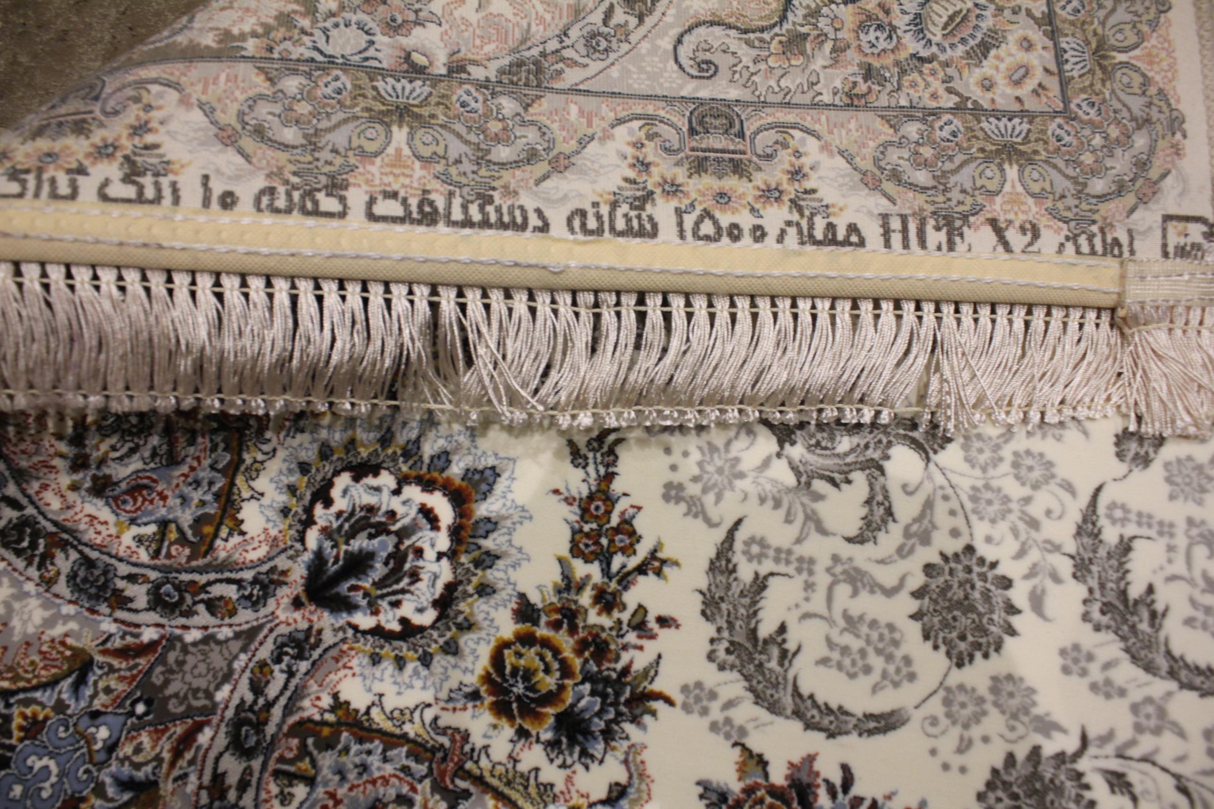 A fine woven Iranian runner, the ivory ground centred with a pair of embossed floral medallions, - Image 2 of 2