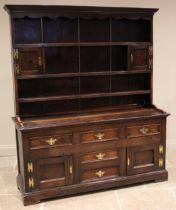 A George III Conwy Valley oak dresser, the enclosed plate rack with a moulded cornice and wavy