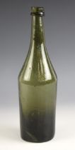 A George III green glass wine bottle, late 18th century, of cylindrical form, the tapering neck with