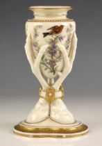 A Royal Worcester porcelain vase, mid 19th century, the central amphora held aloft by three eagle'