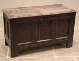 A late 17th/early 18th century oak coffer, the moulded two plank top opening to a fitted candle box,