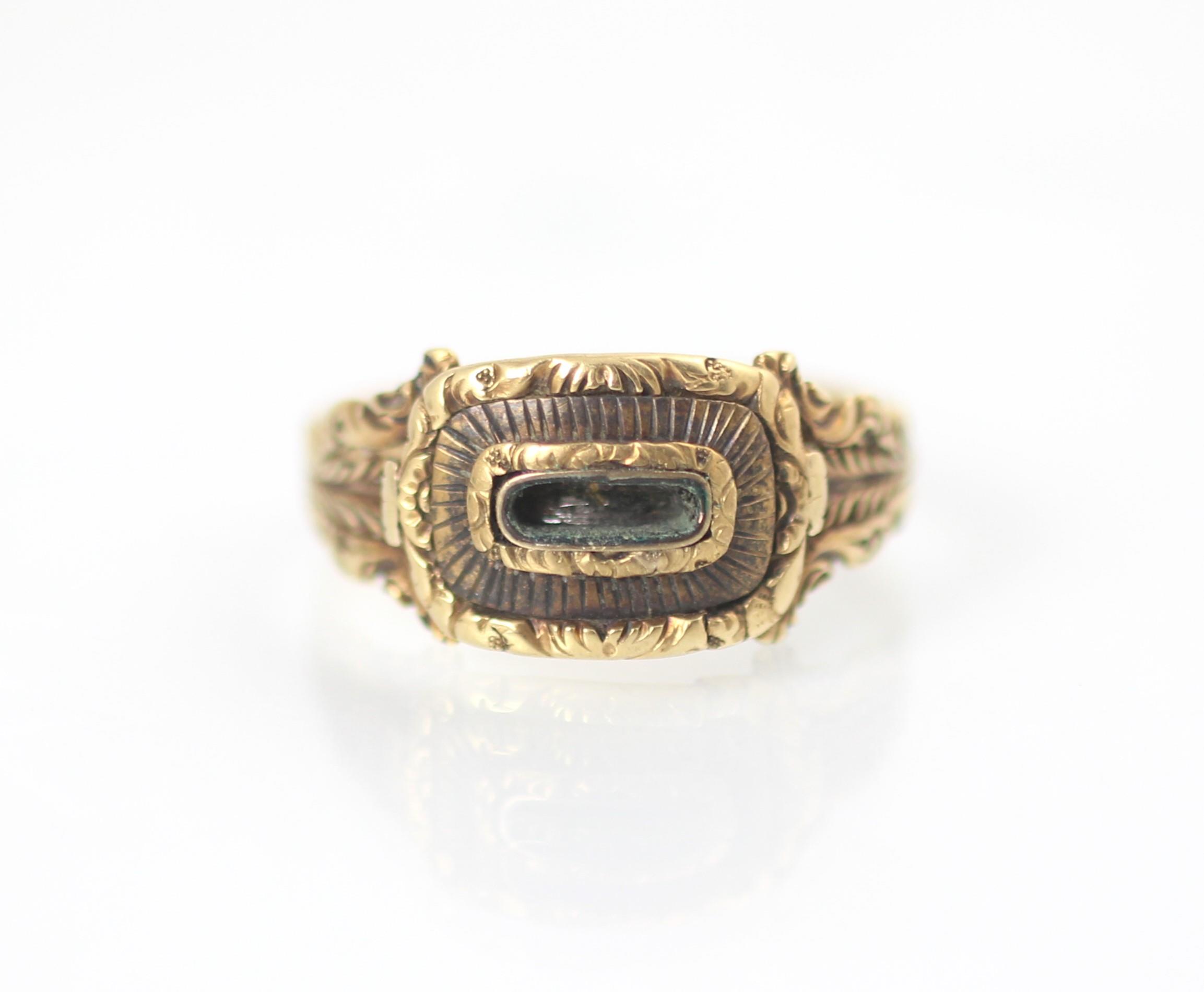 A 19th century style yellow metal mourning ring, the central vacant locket within carved mount and - Image 2 of 4